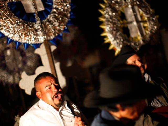 Mexicans pay homage to their dead relatives by preparing meals and decorating their graves