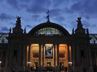 As the sun sets over the international art fair, light illuminates the exhibits through the glass ceilings