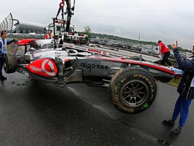 Lewis Hamilton's McLaren is lifted off the track at Hockenheim after he crashed during first practice