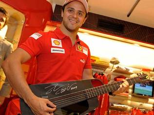 Felipe Massa tests out the Ferrari Blackbird Guitar at Ferrari Maranello Store