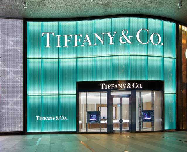 The two-story façade is lit with Tiffany Blue and carved with a wheatleaf pattern similar to that which frames the entrance of Tiffany’s Fifth Avenue flagship store in New York City