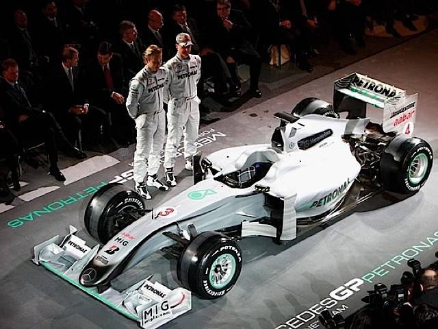 Nico Rosberg and Michael Schumacher pose in front of the new MGP W01