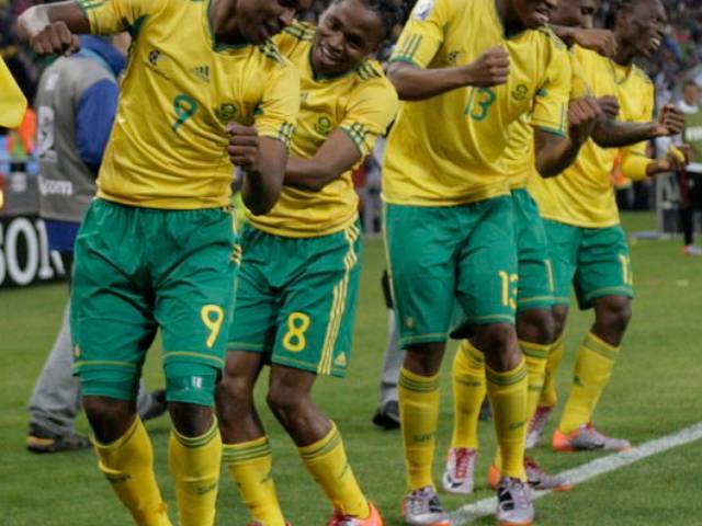 South Africa's Siphiwe Tshabalala (2nd L) dances with team mates after he scored the first goal