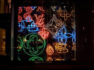 At night, lights from within the store turn on to create the visual effect of a bright candy box
