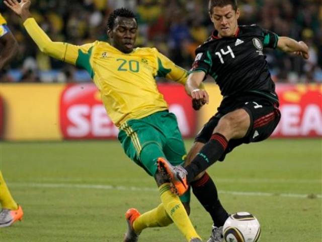 South Africa's Bongani Khumalo, left, competes for the ball with Mexico's Javier Hernandez