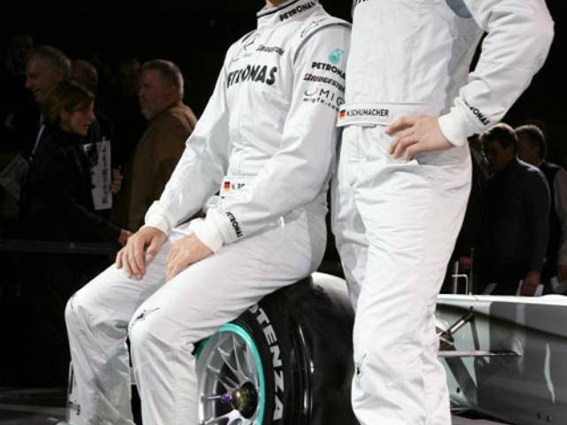 Nico Rosberg and Michael Schumacher pose for a photo during the team presentation